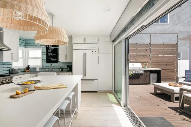 a kitchen with a refrigerator and a sink