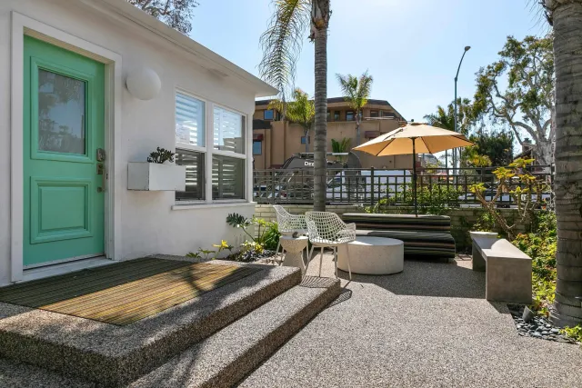 a living room with furniture a table and a potted plant