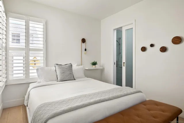 a bathroom with a sink a glass door shower and a mirror