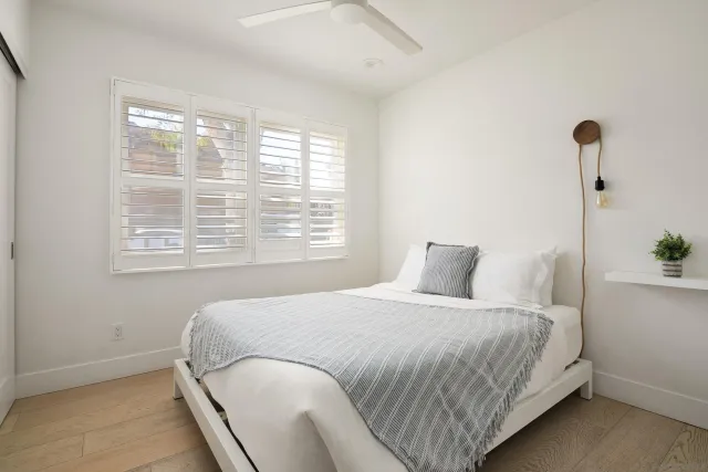 a bedroom with a bed and a window