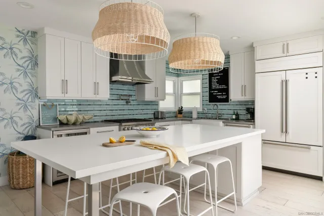 a kitchen with stainless steel appliances a sink a table and chairs