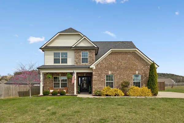 a front view of a house with a yard