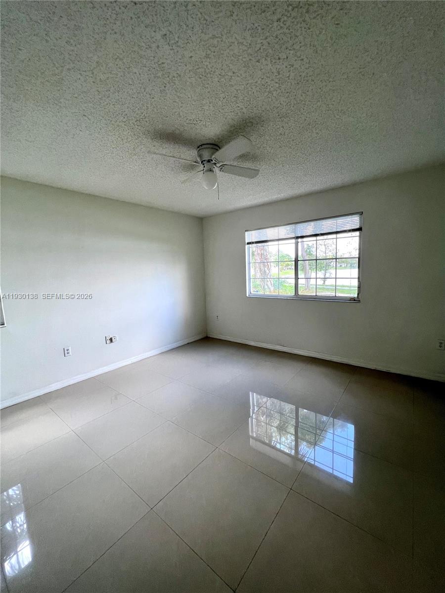 5061 Wiles Road, Unit 102 Coconut Creek, FL 33073 - Photo 11 of 14 a view of an empty room and window