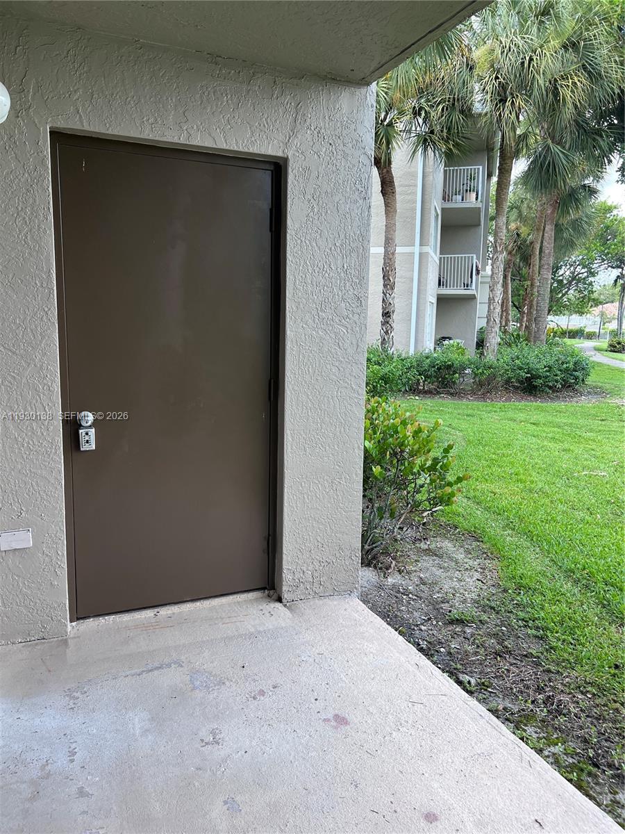 5061 Wiles Road, Unit 102 Coconut Creek, FL 33073 - Photo 13 of 14 a view of a house with backyard