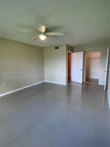 an empty room with a empty space and a ceiling fan