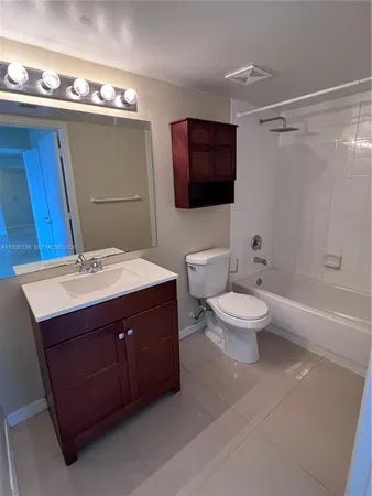 a bathroom with a sink vanity mirror and toilet