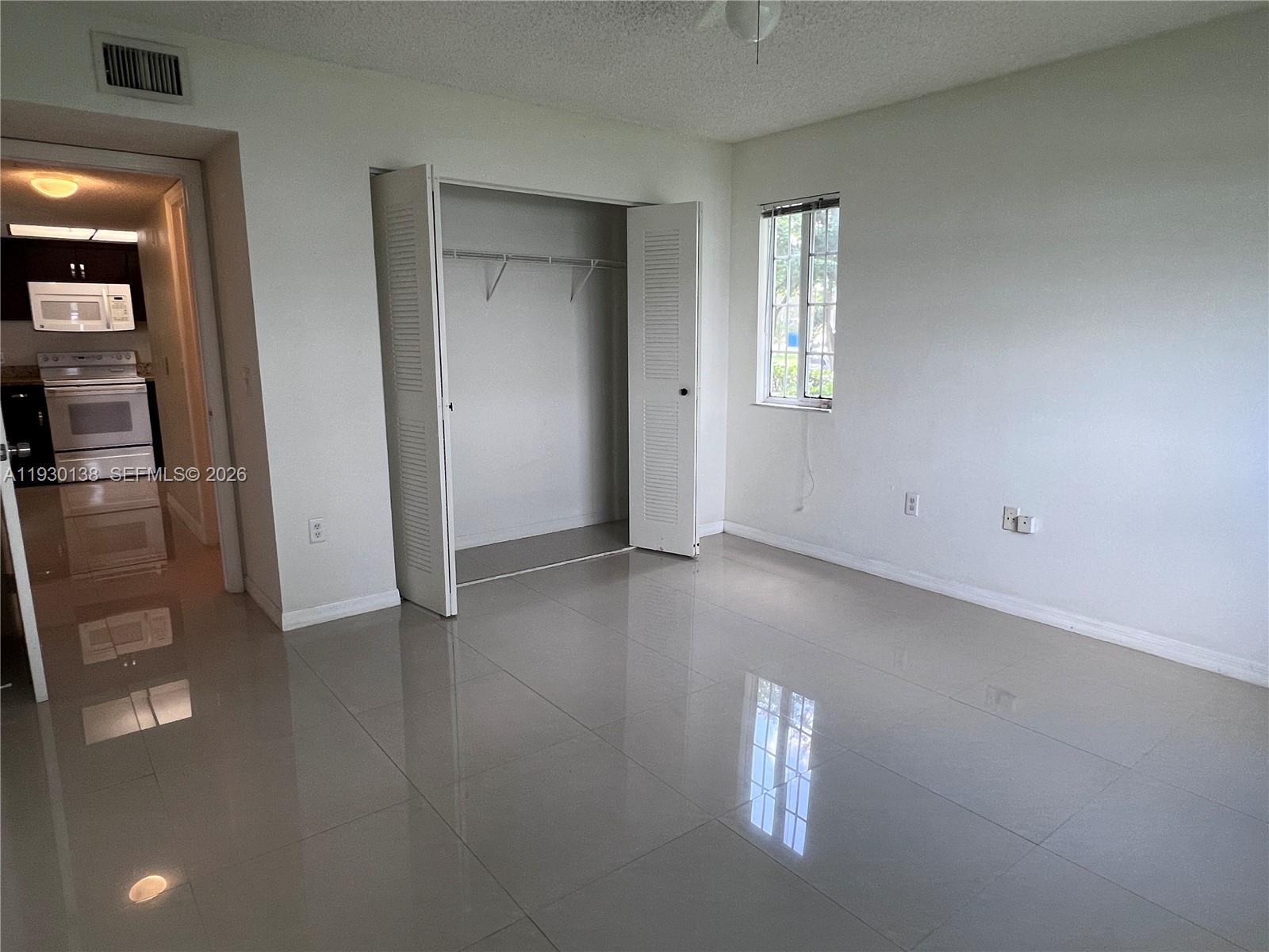 5061 Wiles Road, Unit 102 Coconut Creek, FL 33073 - Photo 10 of 14 an empty room that has a empty room