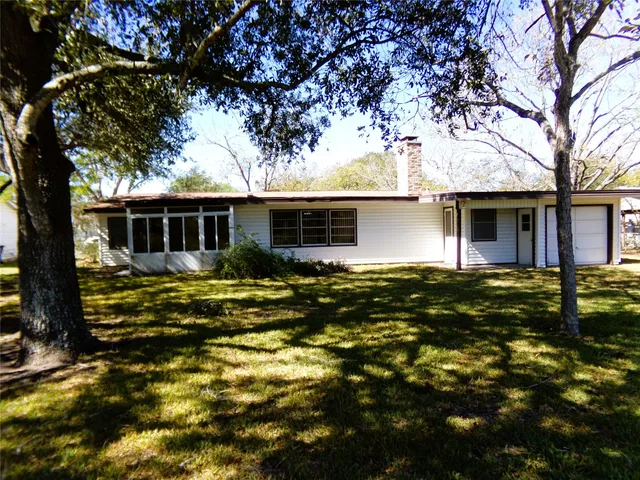 a front view of house with yard and trees