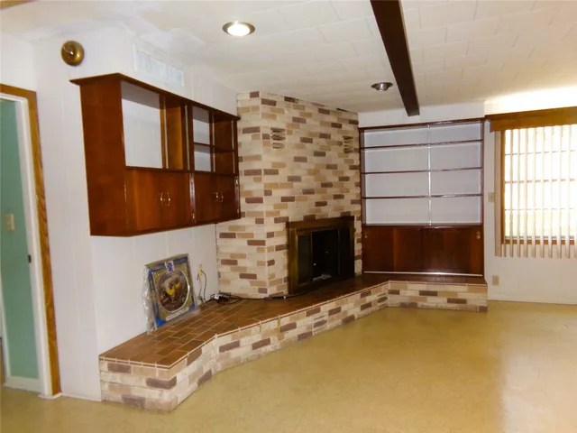 a living room with fireplace furniture and a flat screen tv