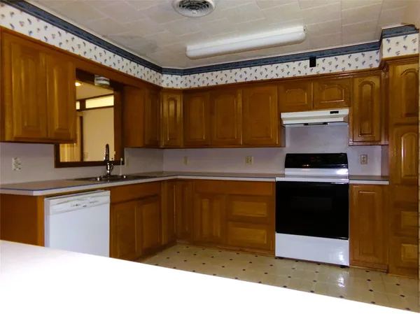 a kitchen with a stove and a sink