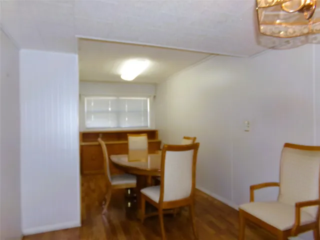 a view of a room with a table and chairs