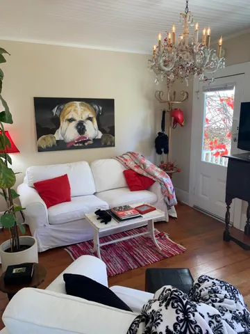 a living room with furniture and a chandelier
