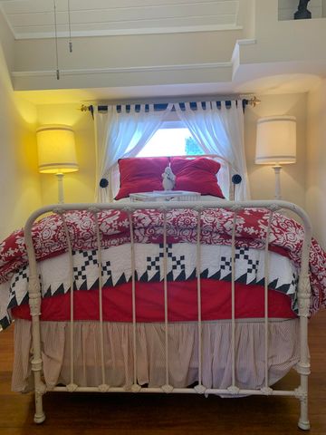 a bed sitting in a bedroom next to a window