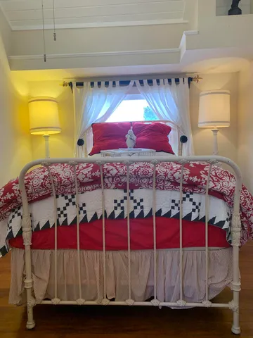 a bed sitting in a bedroom next to a window
