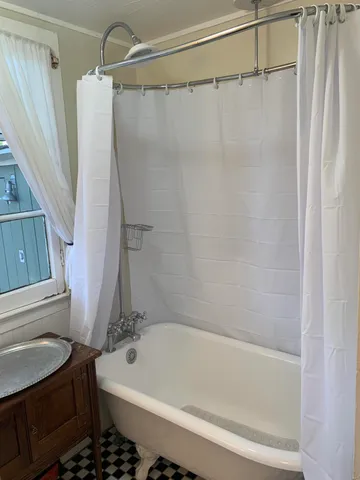 a bathroom with a bath tub and a shower