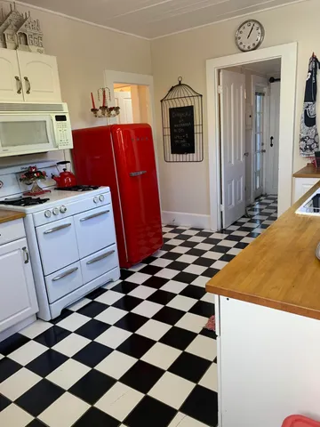 a kitchen with a stove a sink and a refrigerator