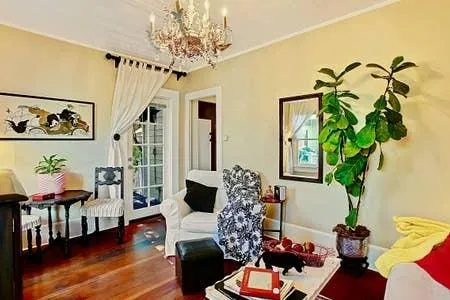 a living room with furniture and a chandelier