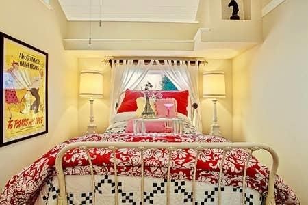 a bedroom with a bed and a painting on the wall