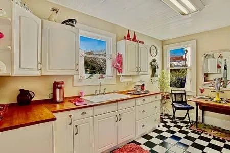 a kitchen with sink cabinets and window