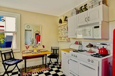 a kitchen with stainless steel appliances a stove a sink and cabinets
