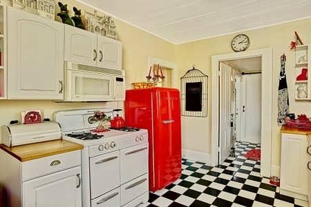 a kitchen with stainless steel appliances a stove a refrigerator and cabinets