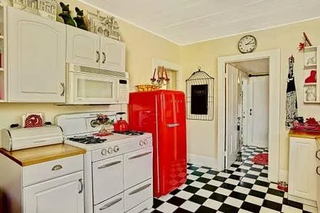 a kitchen with stainless steel appliances a stove a refrigerator and cabinets