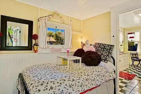 a bed room with a bed and a painting on the wall