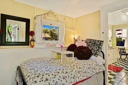 a bed room with a bed and a painting on the wall