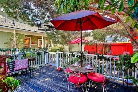 a view of a chairs and table under an umbrella in backyard