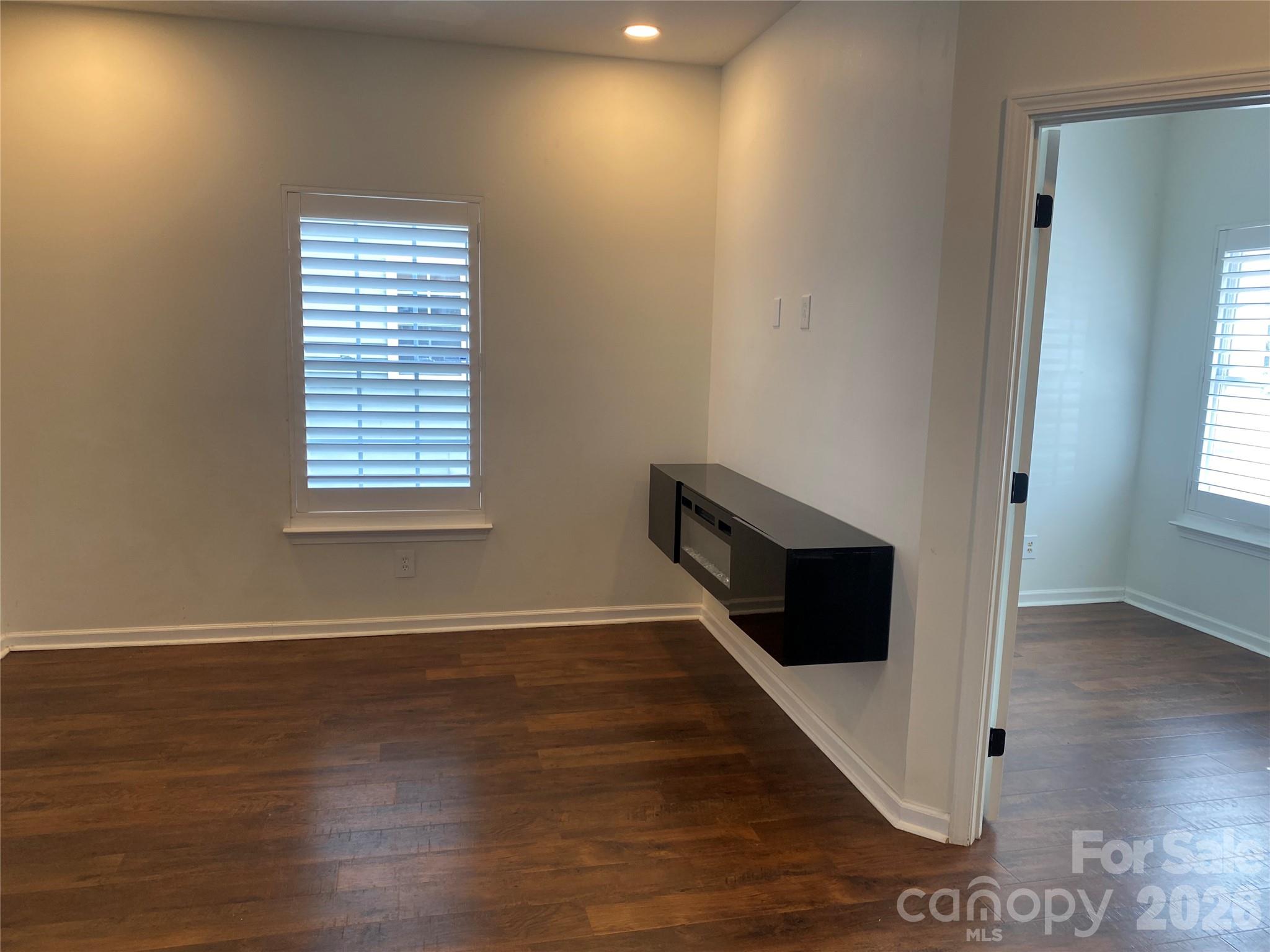 2054 Durand Road Fort Mill, SC 29715 - Photo 12 of 30 a view of an empty room with wooden floor and a window