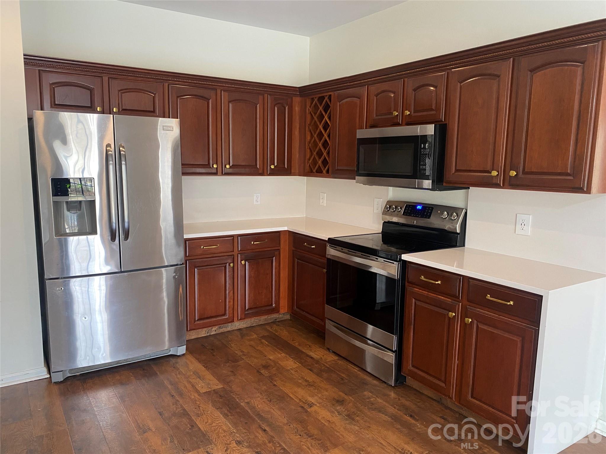 2054 Durand Road Fort Mill, SC 29715 - Photo 6 of 30 a kitchen with stainless steel appliances granite countertop a refrigerator stove a sink dishwasher and wooden cabinets with wooden floor