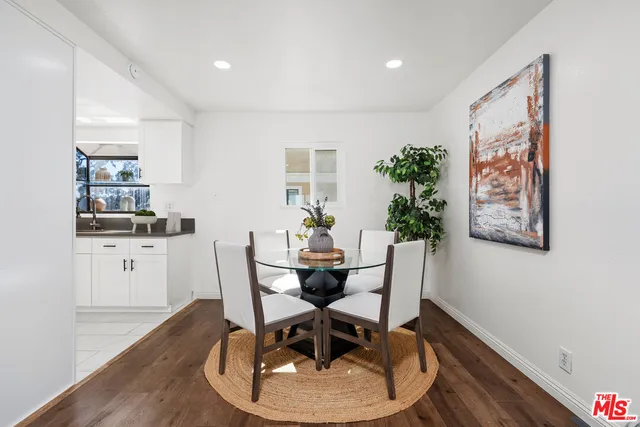 a dining room with furniture and wooden floor