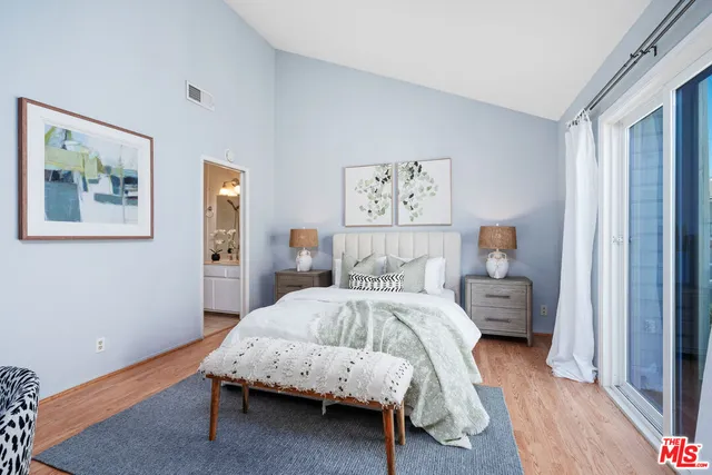 a spacious bedroom with a bed and a large window