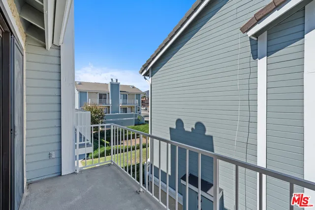 a view of a balcony with furniture
