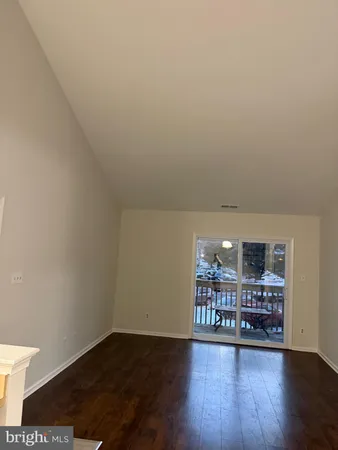 a view of a hardwood & an empty room with wooden floor