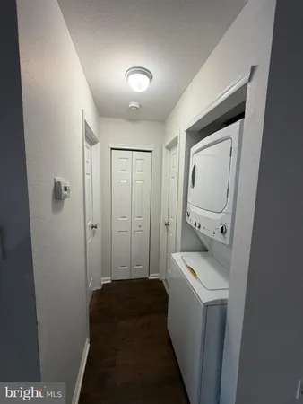 a room with a walk in closet and wooden floor