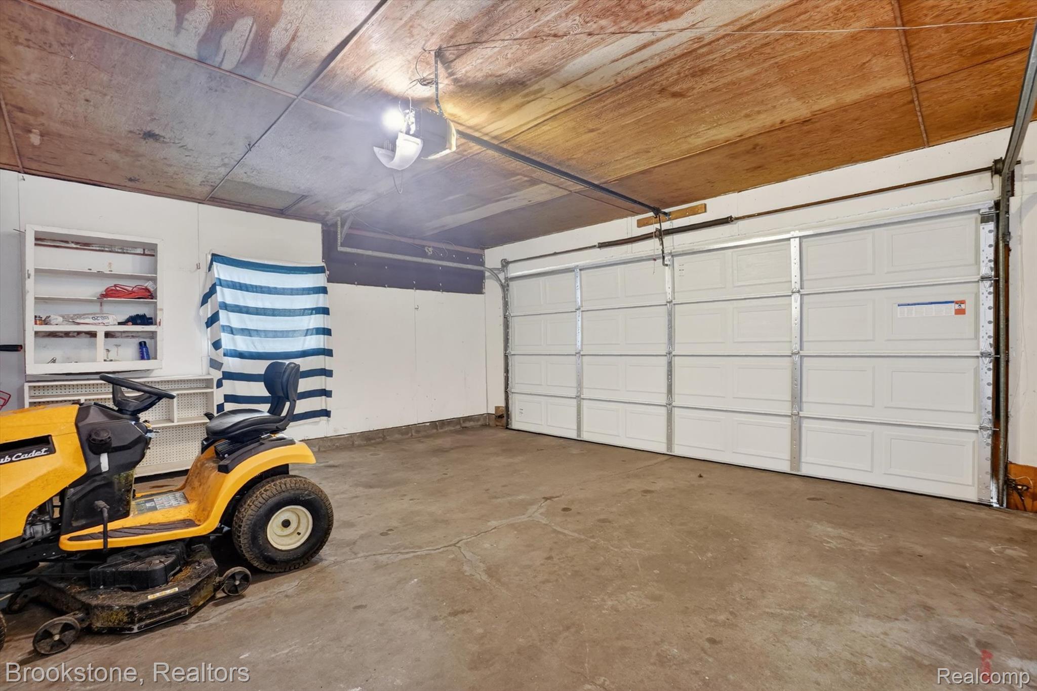 4547 Marlborough Road Okemos, MI 48864 - Photo 25 of 55 Garage featuring a garage door opener