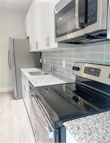 a kitchen with a stove and a microwave