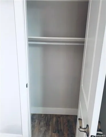 a view of a kitchen with refrigerator and white cabinets