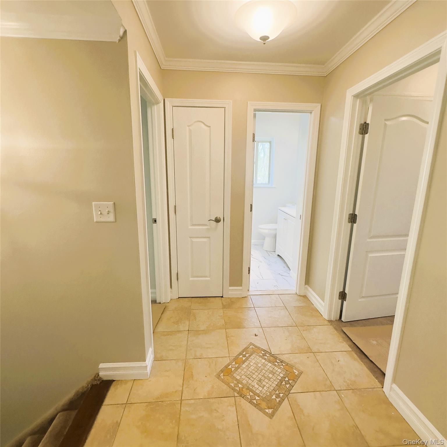 26 Cooper, Unit 603 Poughkeepsie, NY 12603 - Photo 3 of 16 Ceramic flooring, light fixture, linen closet, crown molding.