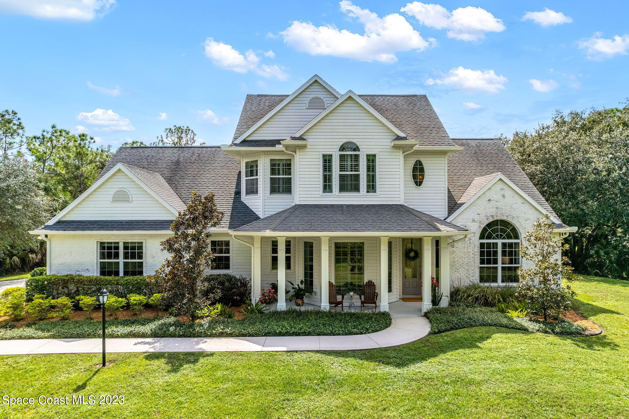 5595 Willoughby Drive Melbourne, FL 32934 - Photo 2 of 40 a front view of a house with a yard