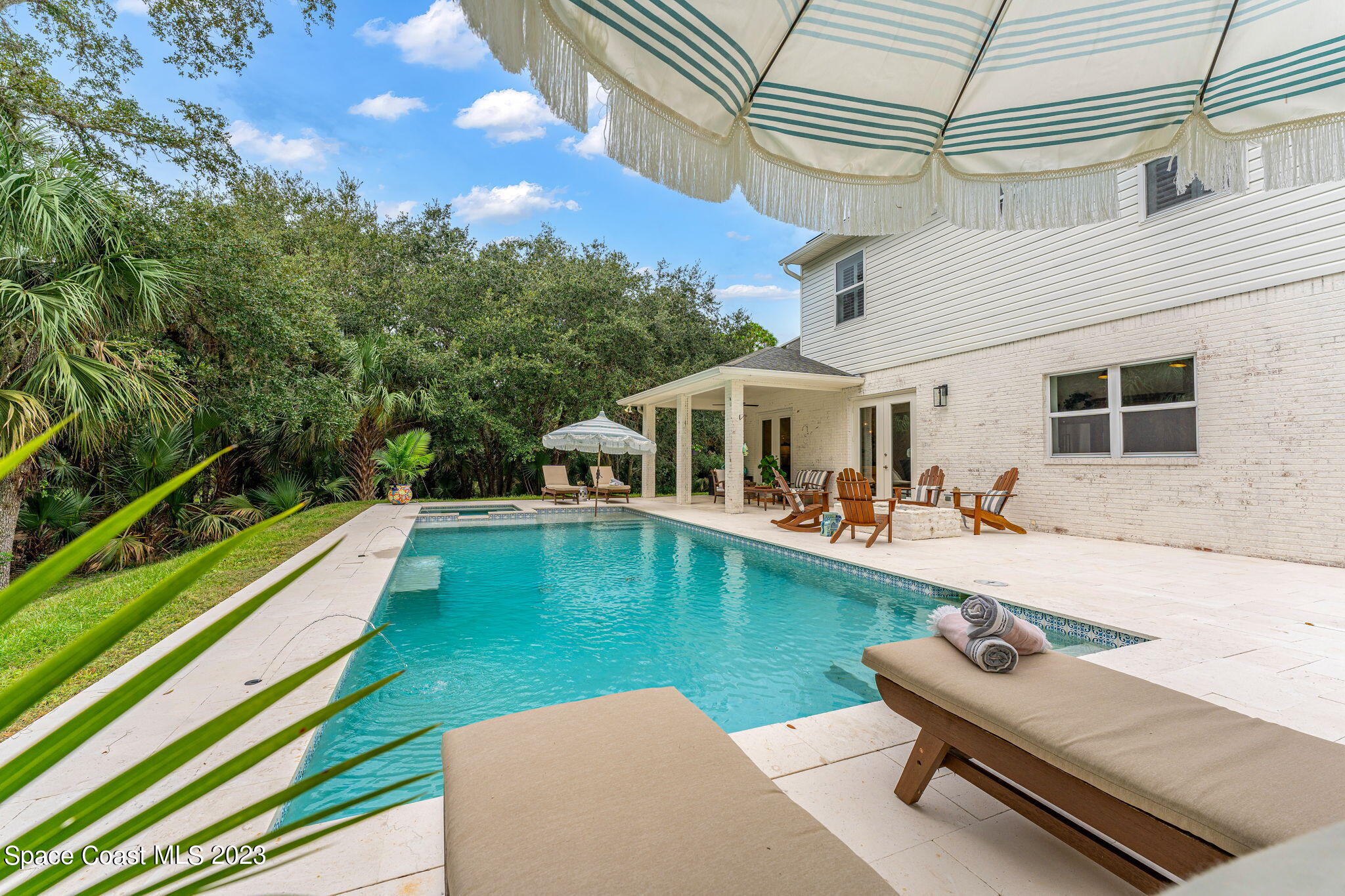 5595 Willoughby Drive Melbourne, FL 32934 - Photo 24 of 40 a view of a house with swimming pool and a yard