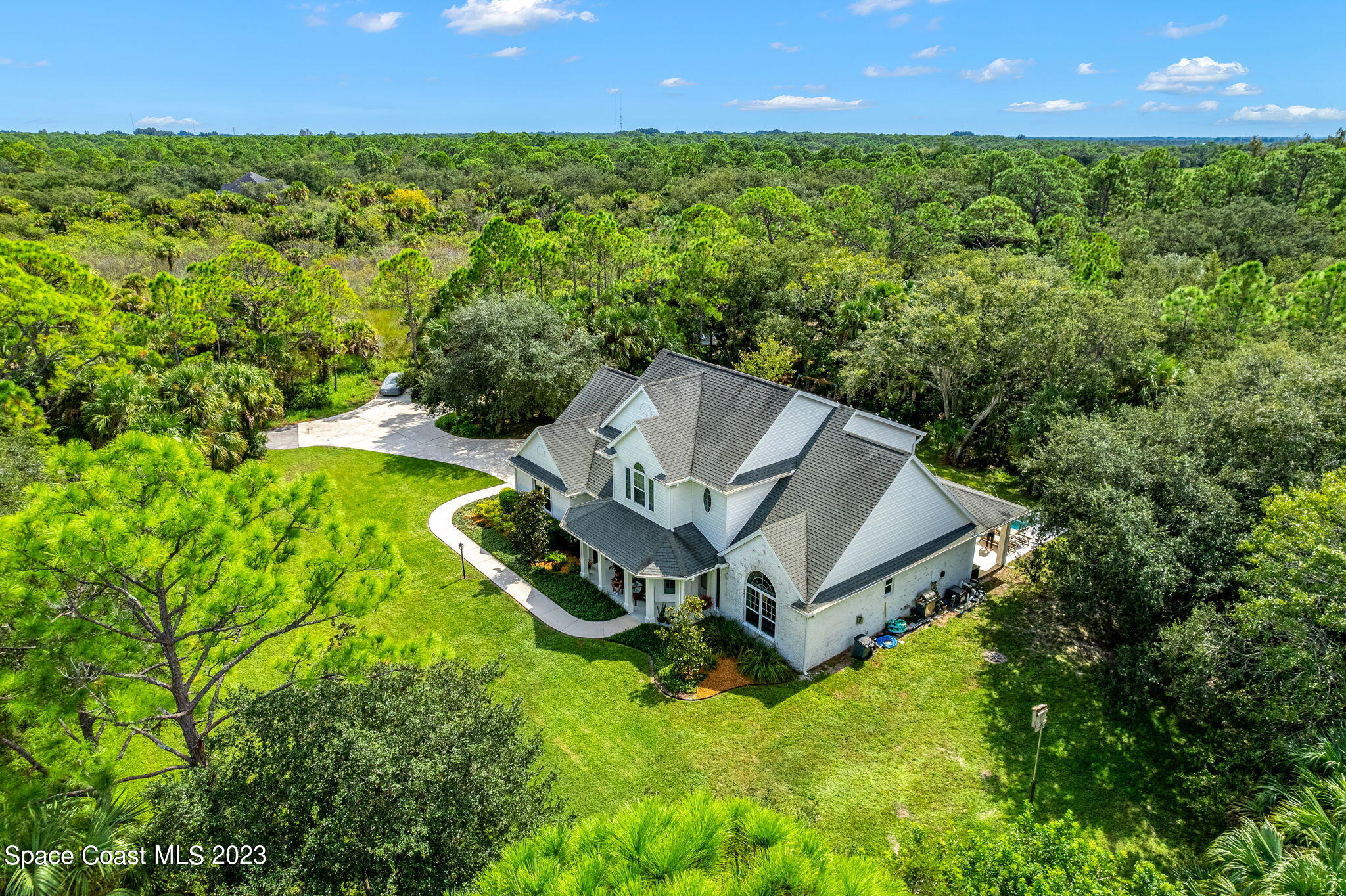 5595 Willoughby Drive Melbourne, FL 32934 - Photo 32 of 40 a view of a house with a yard and a fountain