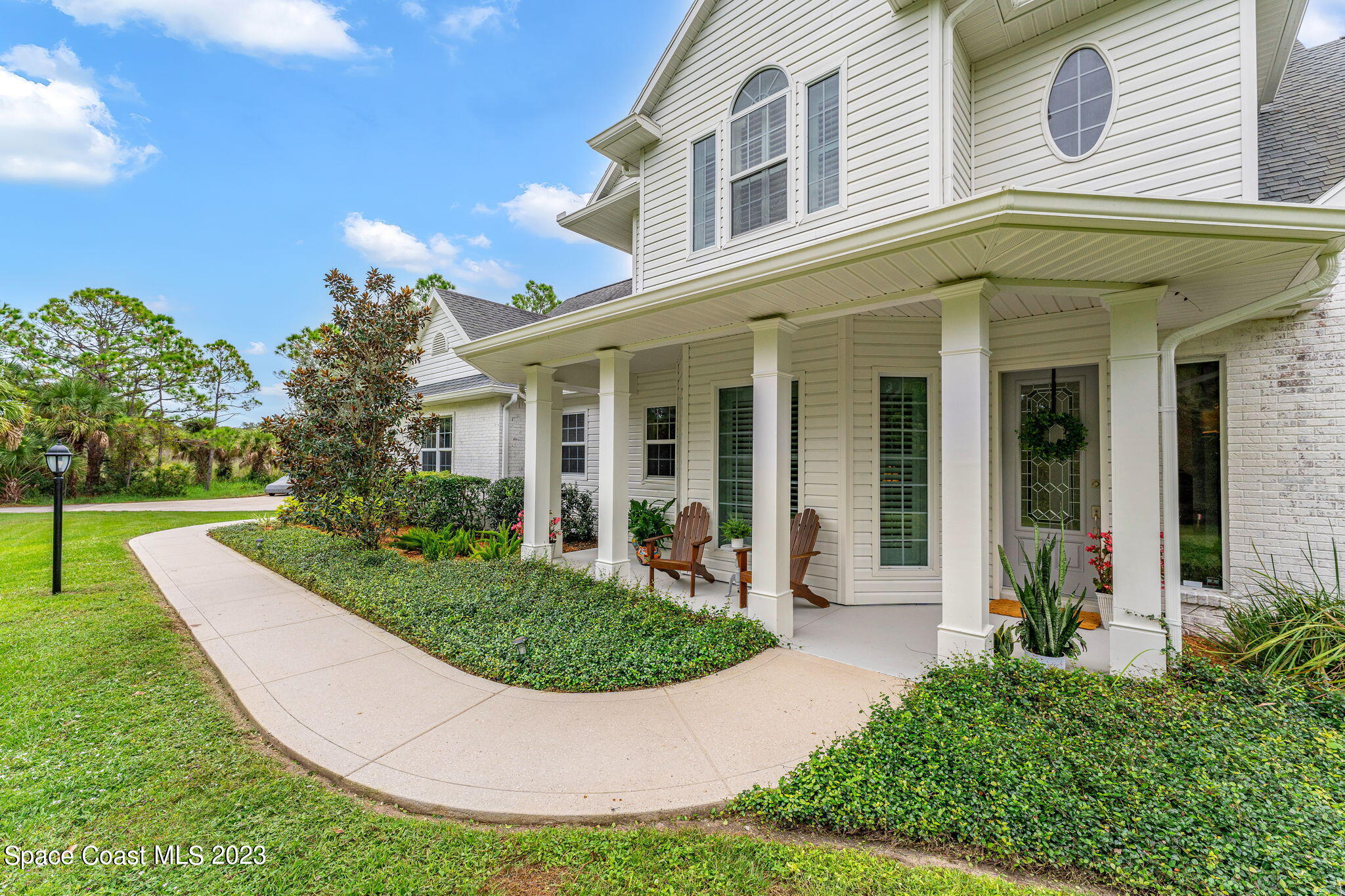 5595 Willoughby Drive Melbourne, FL 32934 - Photo 39 of 40 a view of a house with fountain and a garden