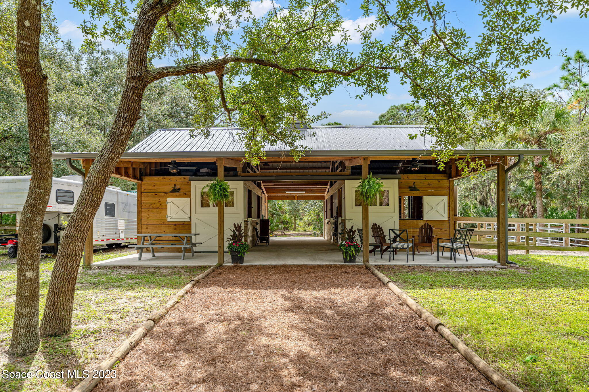 5595 Willoughby Drive Melbourne, FL 32934 - Photo 4 of 40 a front view of a house with a garden and patio