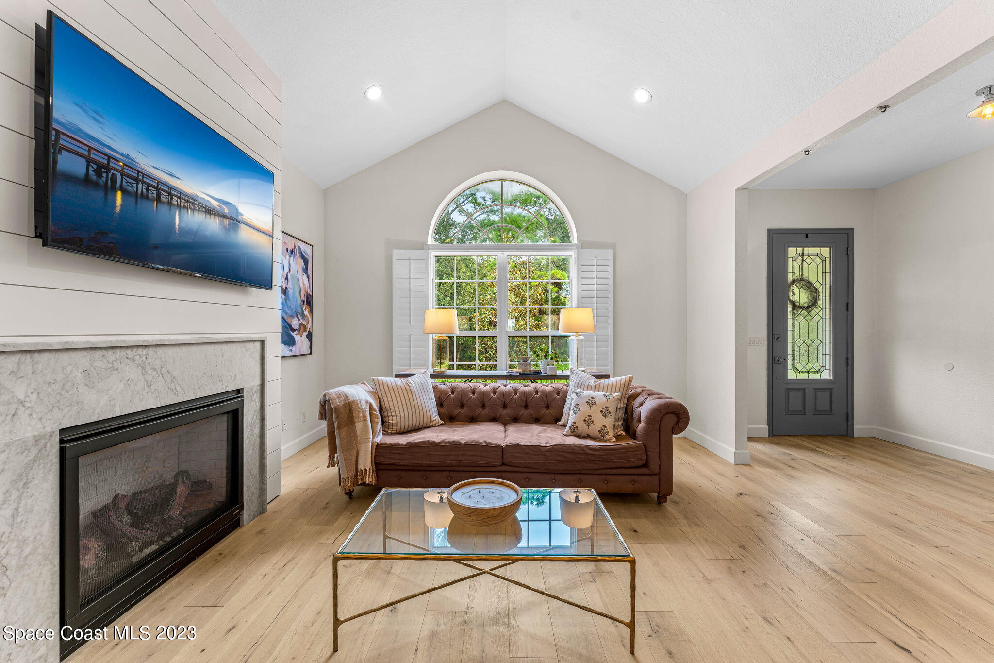 5595 Willoughby Drive Melbourne, FL 32934 - Photo 5 of 40 a living room with furniture and a fireplace