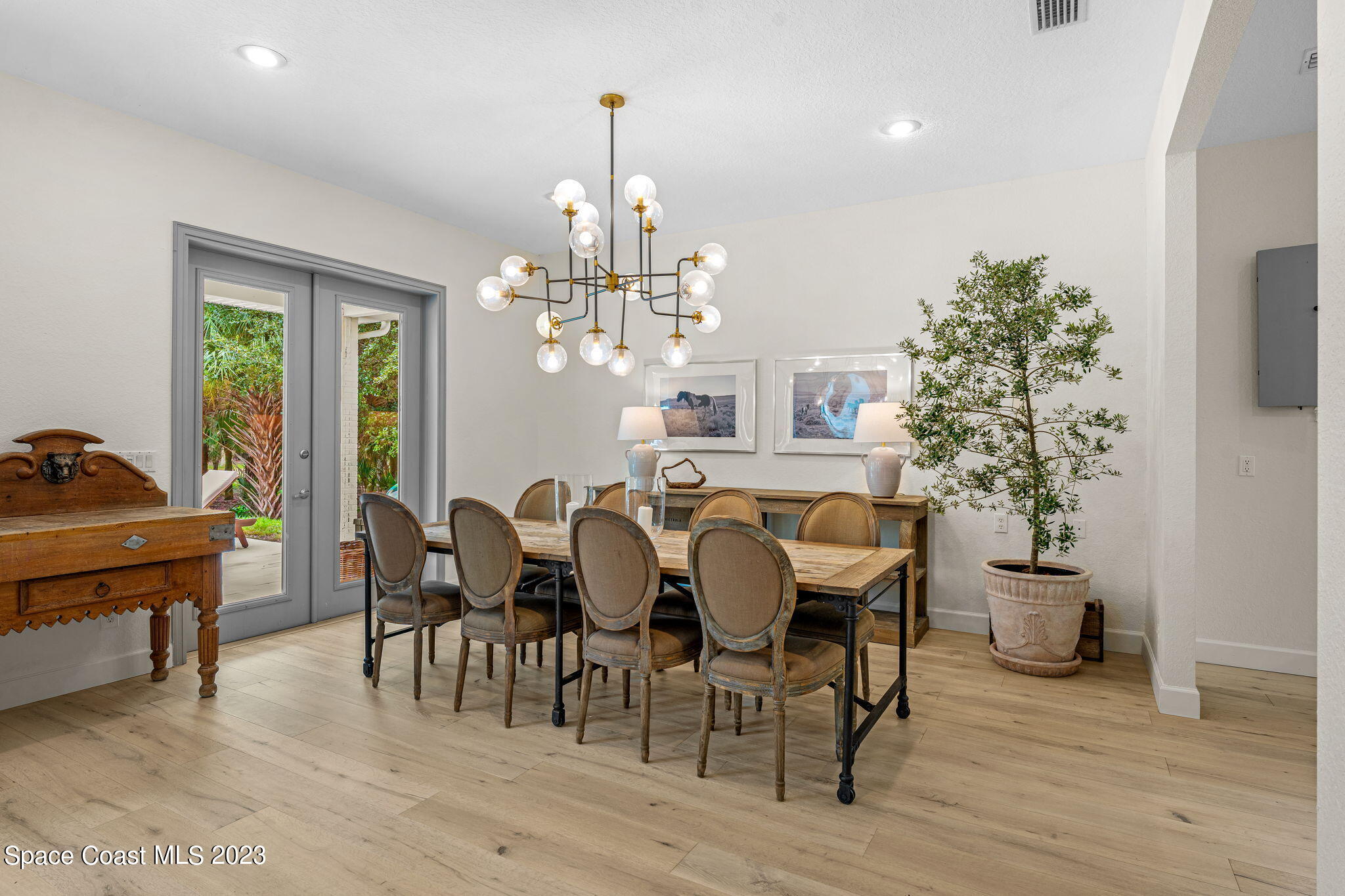 5595 Willoughby Drive Melbourne, FL 32934 - Photo 7 of 40 a view of a dining room with furniture window and wooden floor