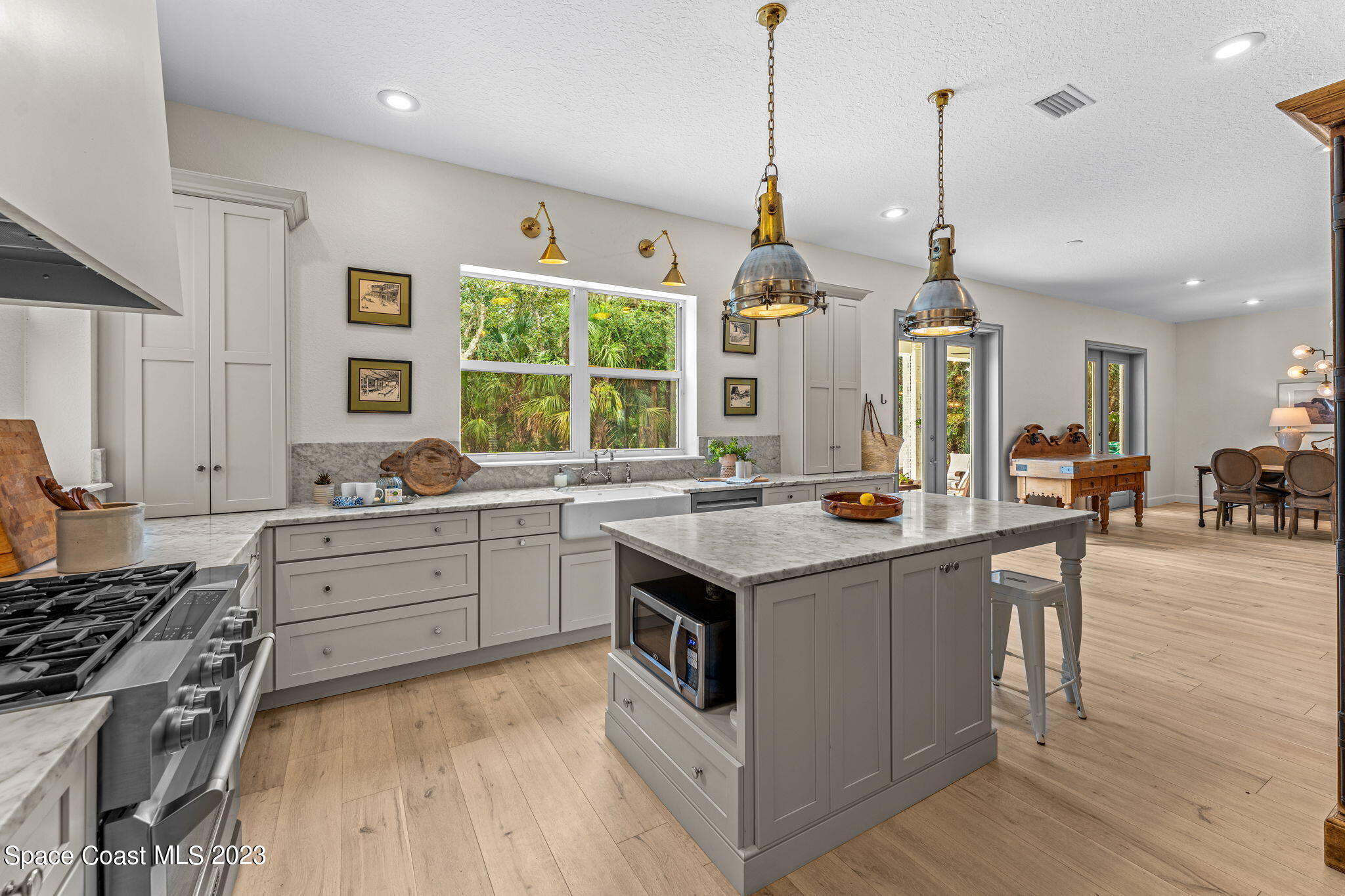 5595 Willoughby Drive Melbourne, FL 32934 - Photo 10 of 40 a kitchen with stainless steel appliances granite countertop a stove and a sink
