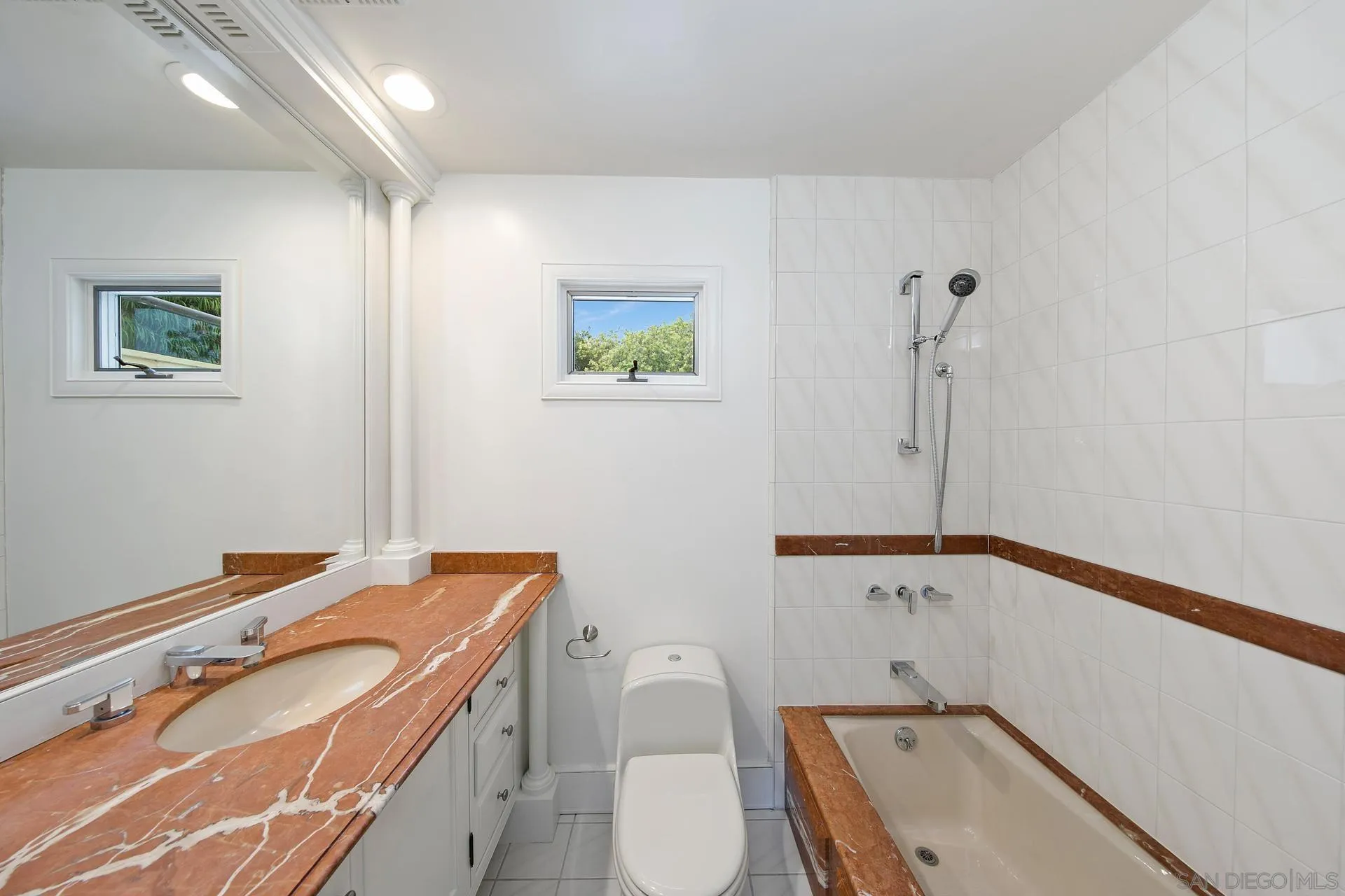 1735 Seaview Avenue Del Mar, CA 92014 - Photo 11 of 51 a bathroom with a sink a toilet and a mirror