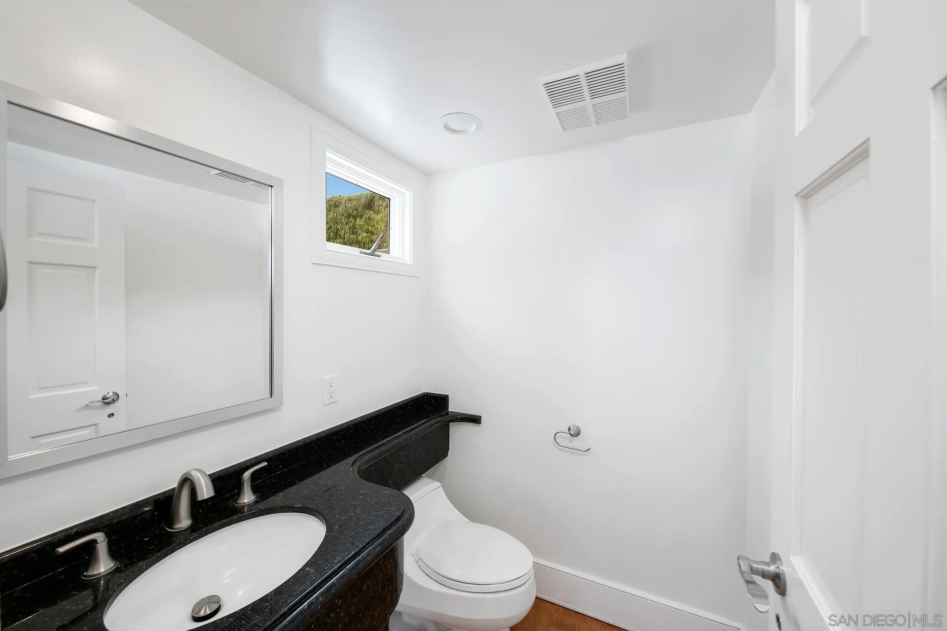 1735 Seaview Avenue Del Mar, CA 92014 - Photo 13 of 51 a bathroom with a toilet a sink and mirror